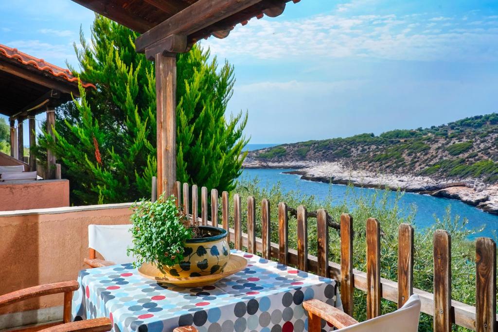 a table with a potted plant on top of a balcony at Giola Bungalows Sirines in Astris