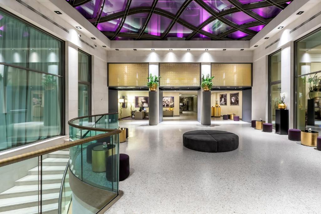 a lobby of a building with a purple ceiling at Rosa Grand Milano - Starhotels Collezione in Milan