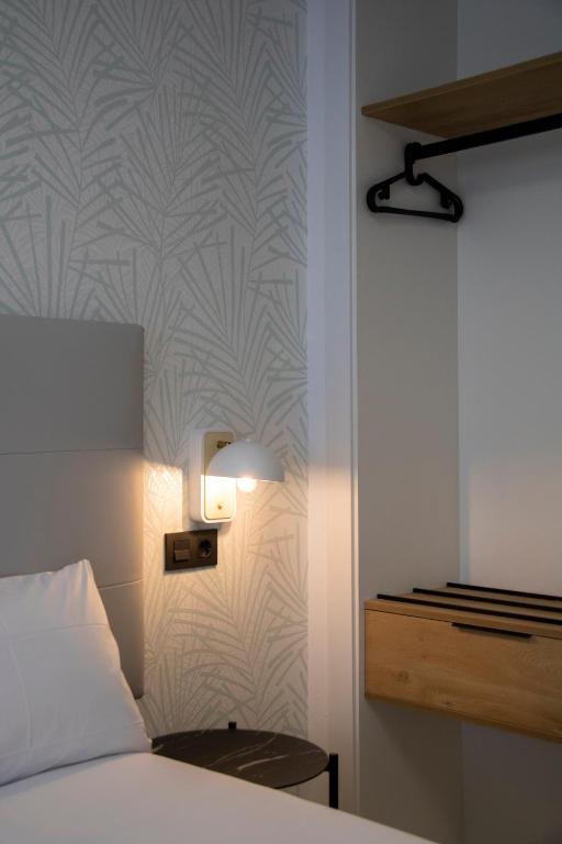 Postel nebo postele na pokoji v ubytování Hotel Alda Orzán