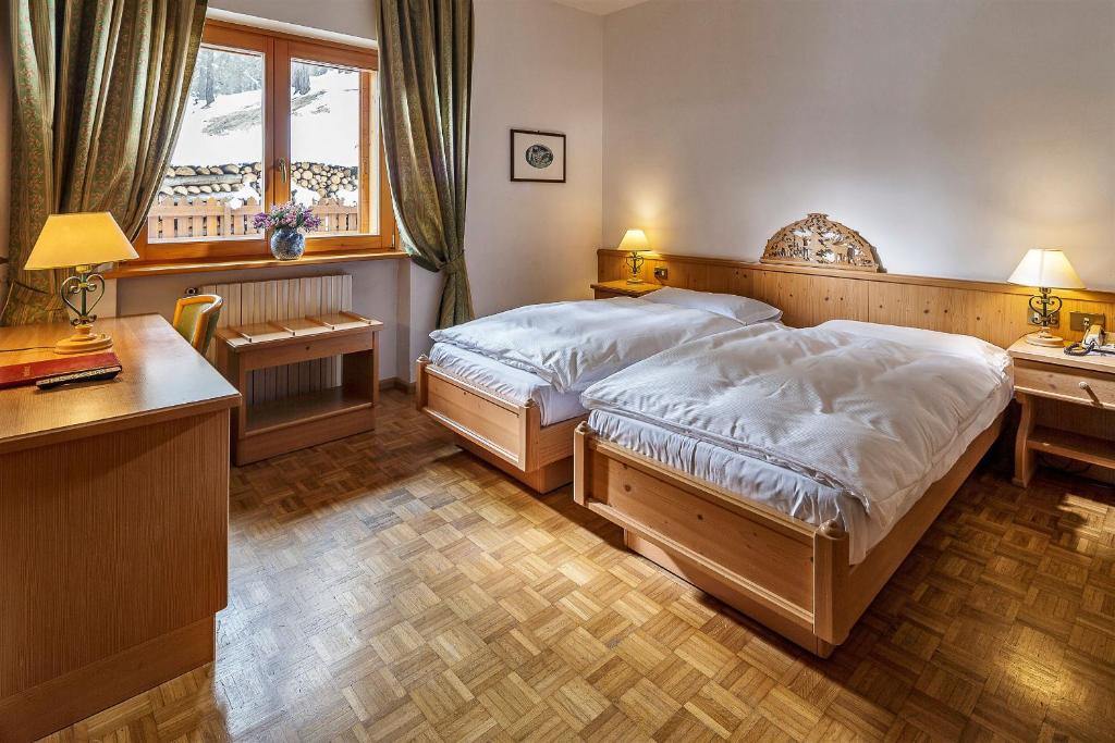 Кровать или кровати в номере Hotel Piccolo Pocol