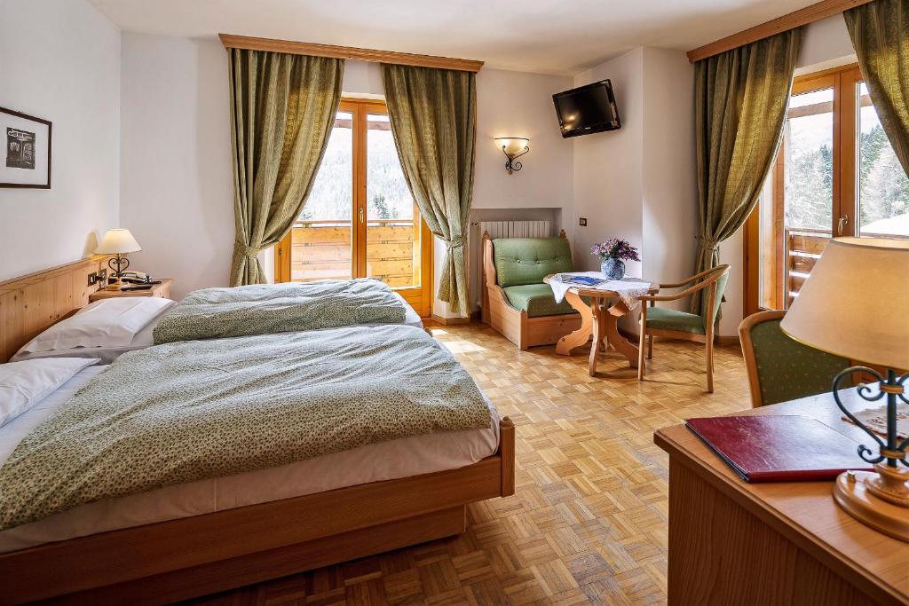 Кровать или кровати в номере Hotel Piccolo Pocol