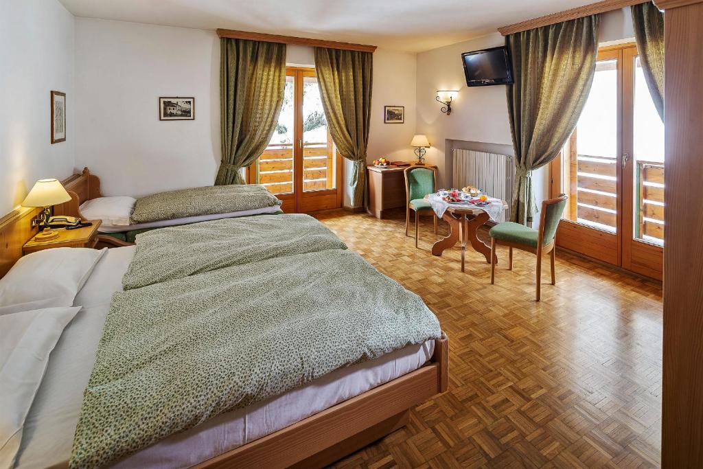 Кровать или кровати в номере Hotel Piccolo Pocol