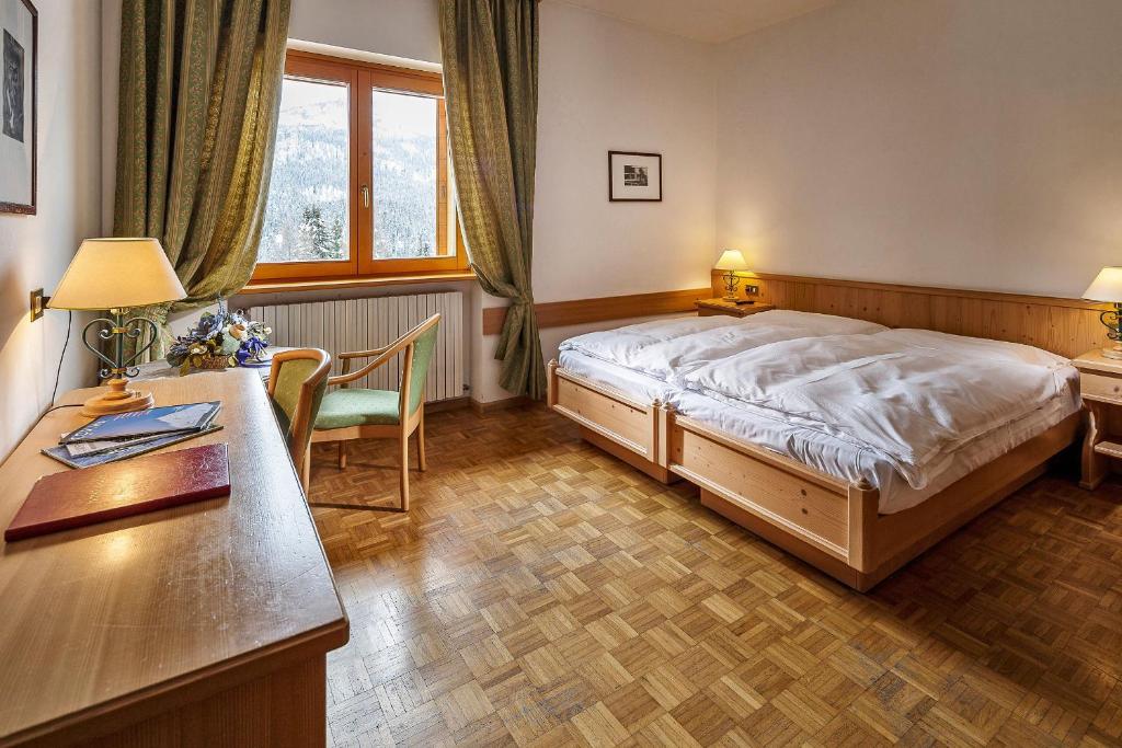 Кровать или кровати в номере Hotel Piccolo Pocol