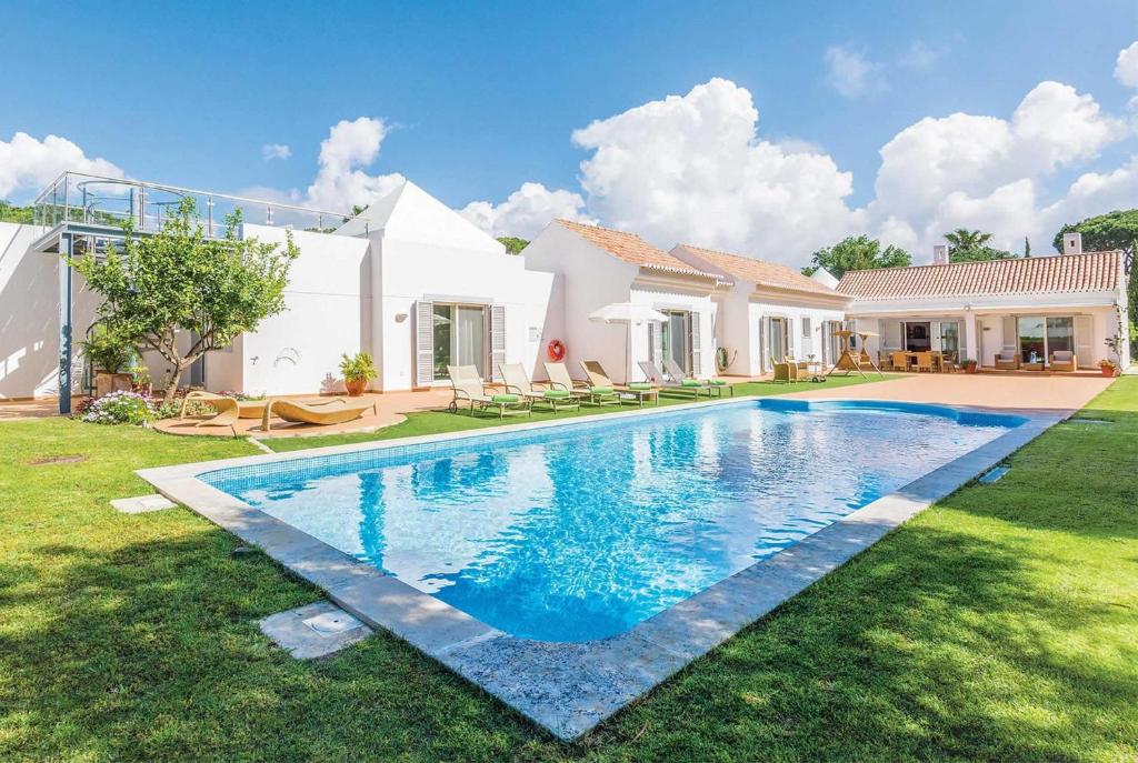 a swimming pool in the yard of a house at Two Towers in Vale do Lobo