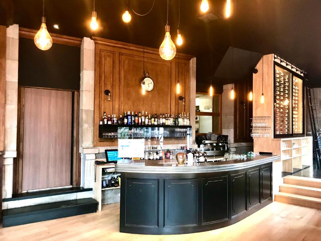 a bar in a restaurant with a counter top at The Originals Boutique, Grand Hôtel Saint-Pierre, Aurillac (Qualys-Hotel) in Aurillac