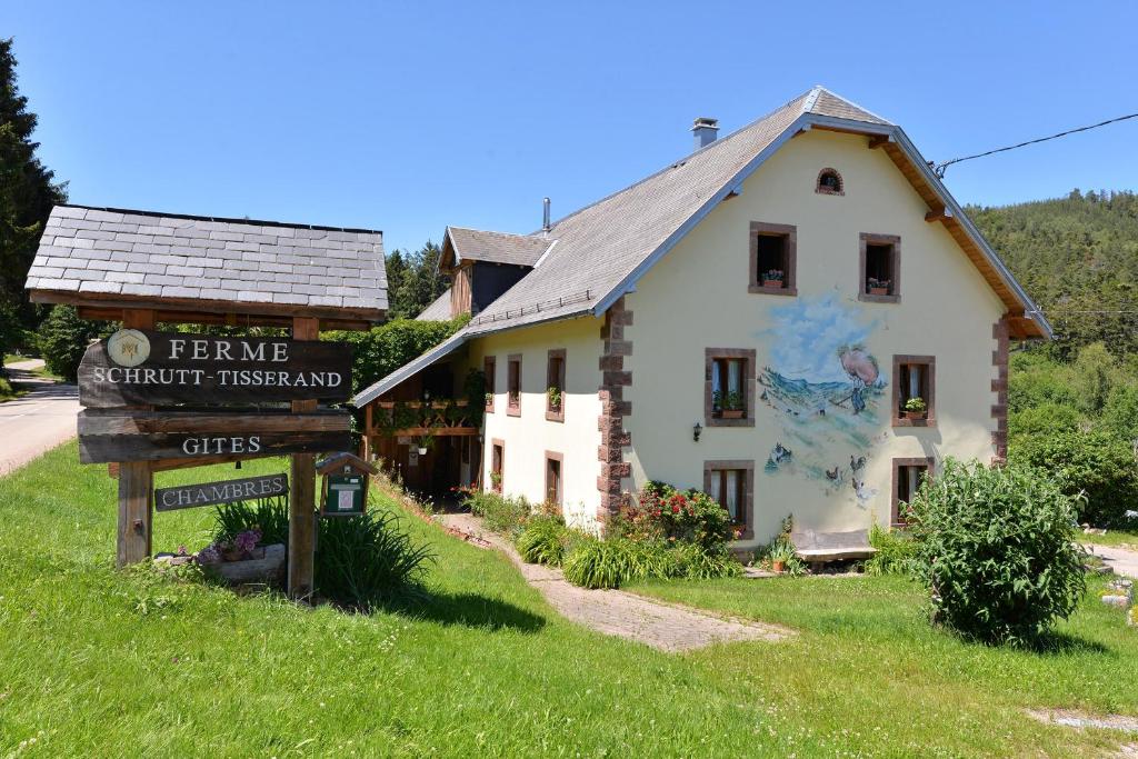 a building with a sign in front of it at Gites ou Chambres d'hôtes à la ferme in Orbey