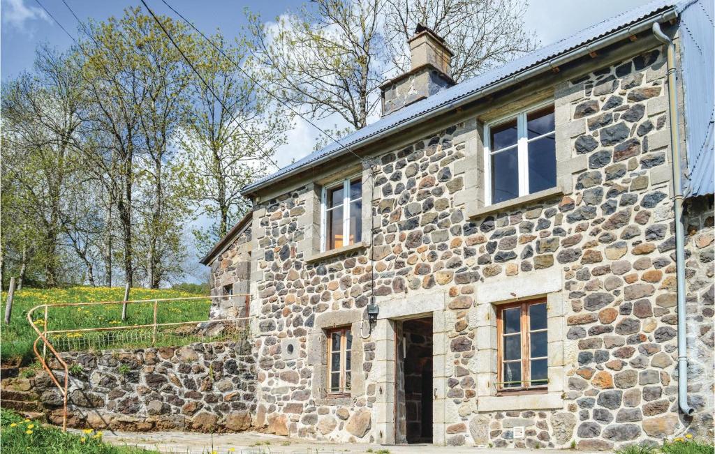 an old stone building with a tower on top of it at Gorgeous Home In Cheylade With House A Mountain View in Cheylade