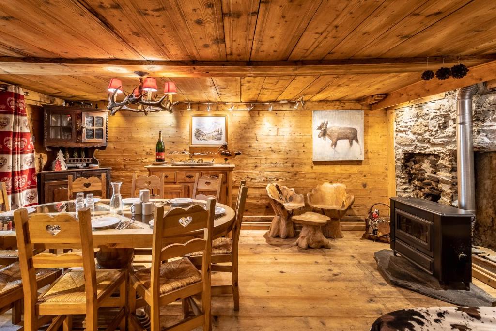 a dining room with a table and a fireplace at CHALET PELE - Alpes Travel - Central Chamonix - Sleeps 11 in Chamonix