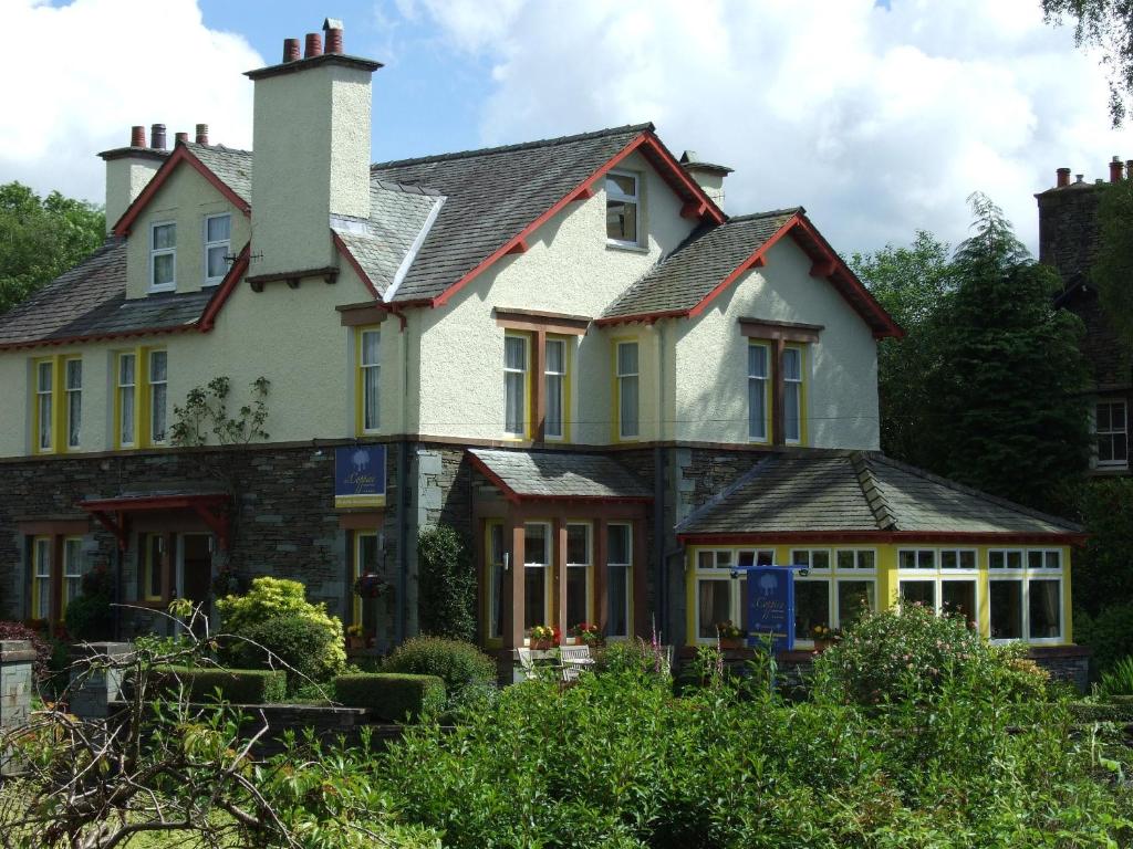 a large white house with a chimney at The Coppice - including off-site health club in Windermere