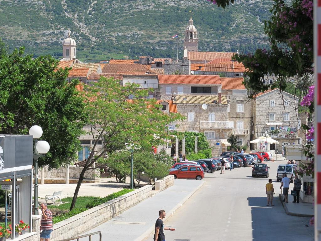 a city street with people walking down the street at Apartments Viva in Korčula