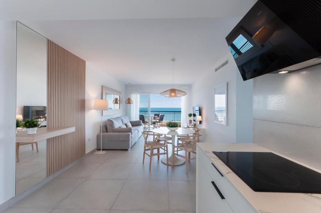 a kitchen and living room with a view of the ocean at AG SAN PAULO PREMIUM in Playa de Gandia