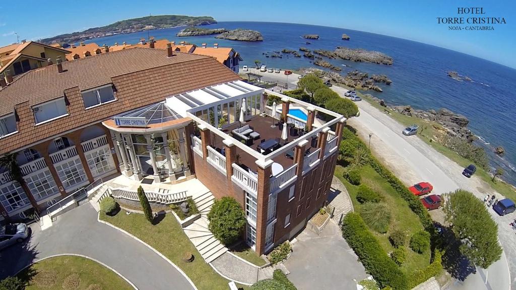 an aerial view of a building next to the water at Hotel Torre Cristina in Noja