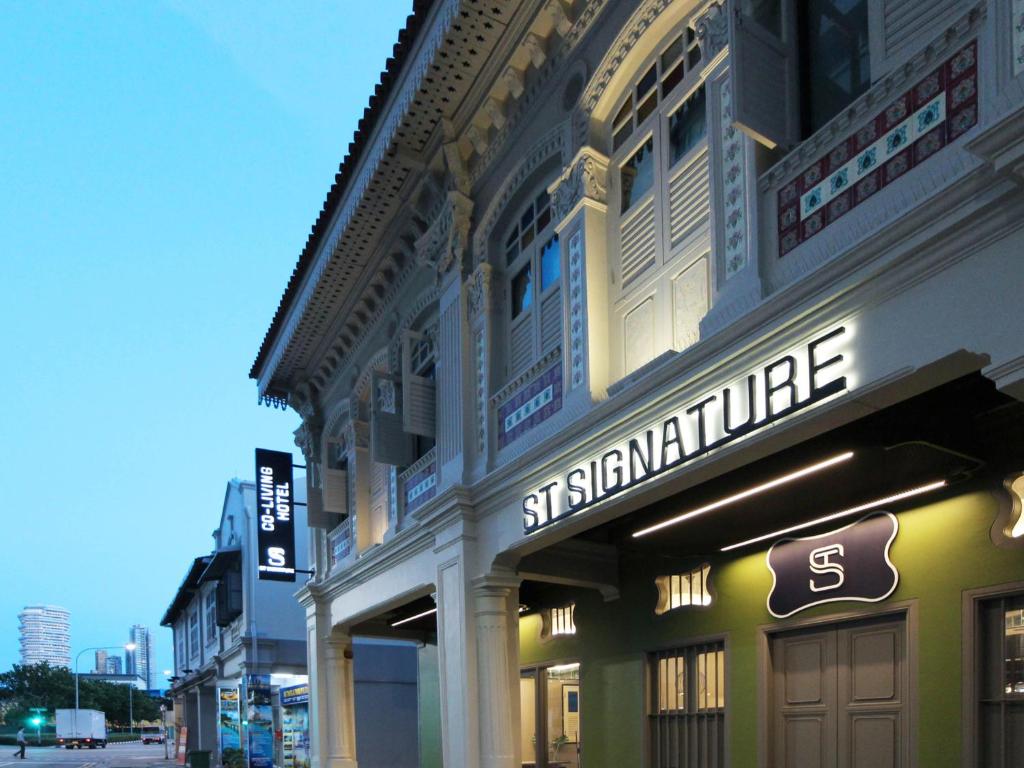 a building with a sign for a store on a street at ST Signature Jalan Besar, SHORT OVERNIGHT, 8 Hours, 1159PM-8AM in Singapore