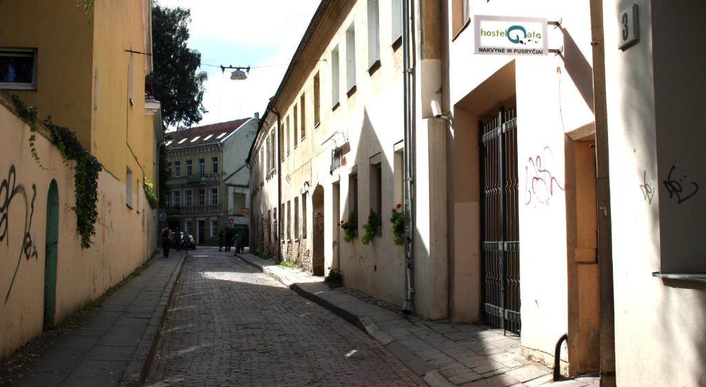 an alley with buildings and a street sign on the side at Mikalo House in Vilnius