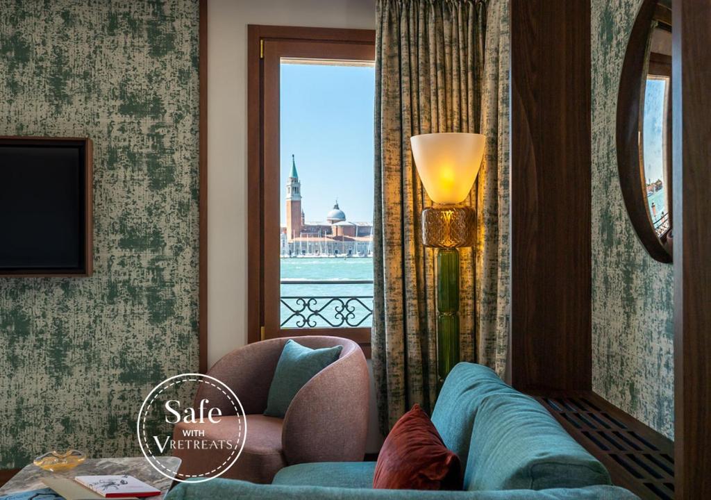a living room with a couch and a window at Ca'di Dio-Small Luxury Hotel in Venice