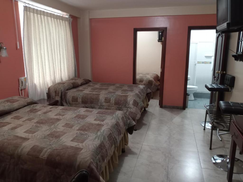 Postel nebo postele na pokoji v ubytování Hostal EL CALLEJÓN
