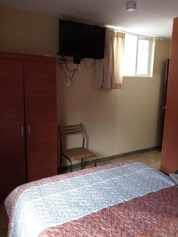 Postel nebo postele na pokoji v ubytování Hostal EL CALLEJÓN