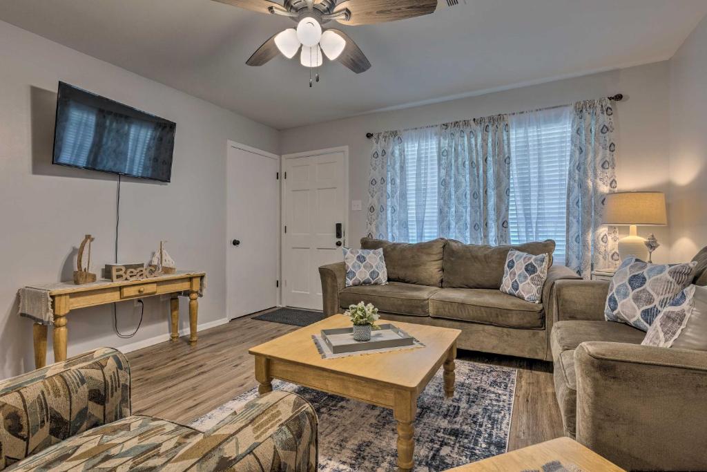 a living room with a couch and a table at Charming Gulfport Escape Half-Mile to Beach! in Gulfport