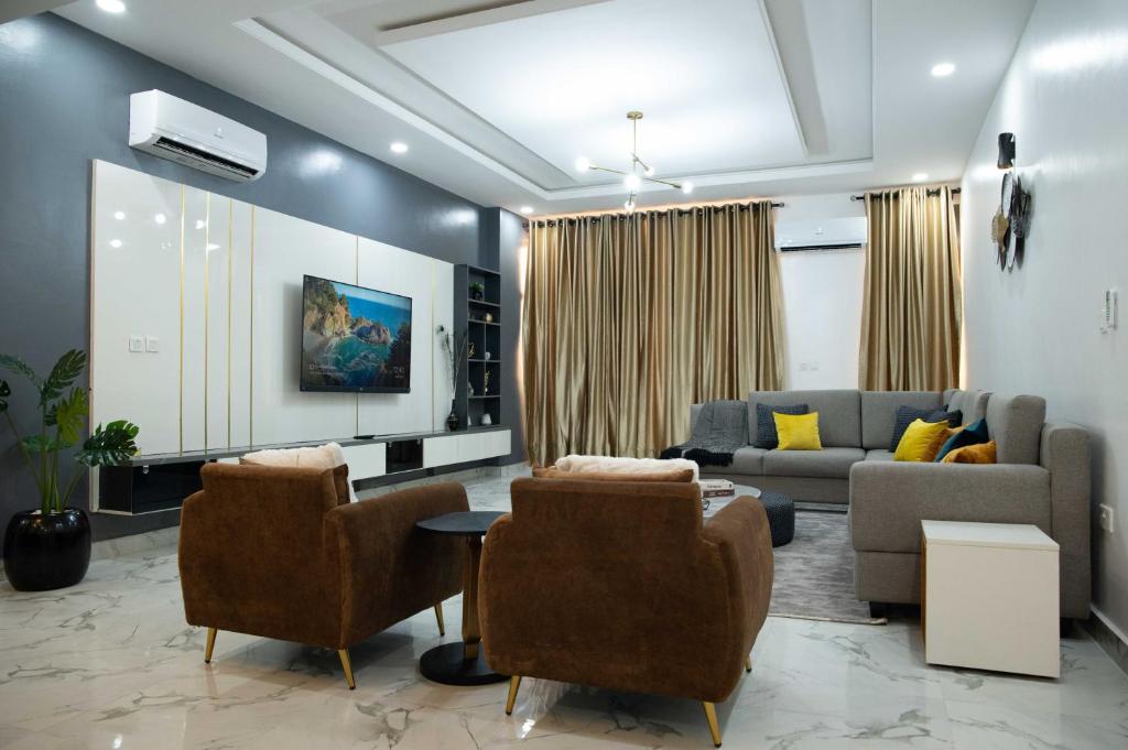 a living room with a couch and a table and chairs at Kay's Comfort Place in Lekki