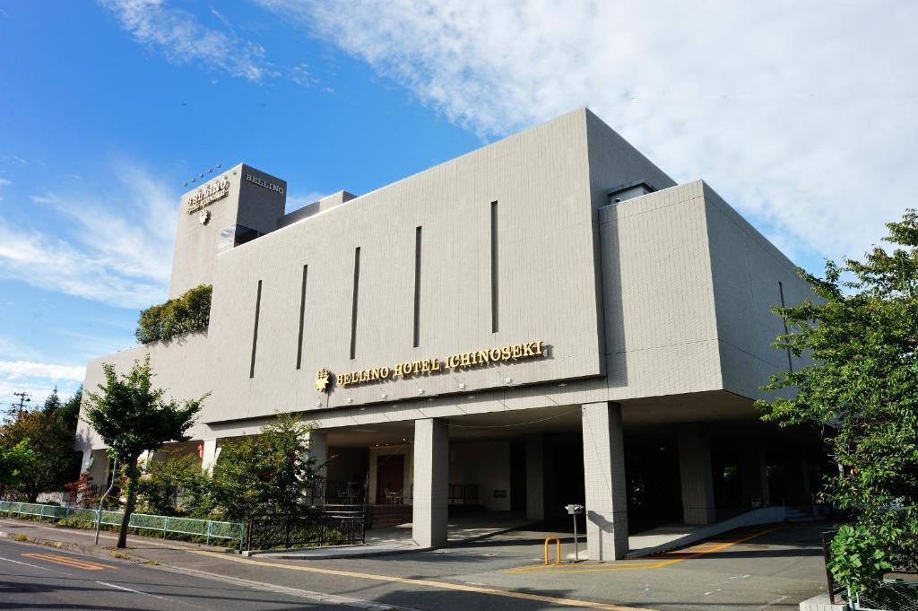 a large white building with a sign on it at Bellino Hotel Ichinoseki in Ichinoseki