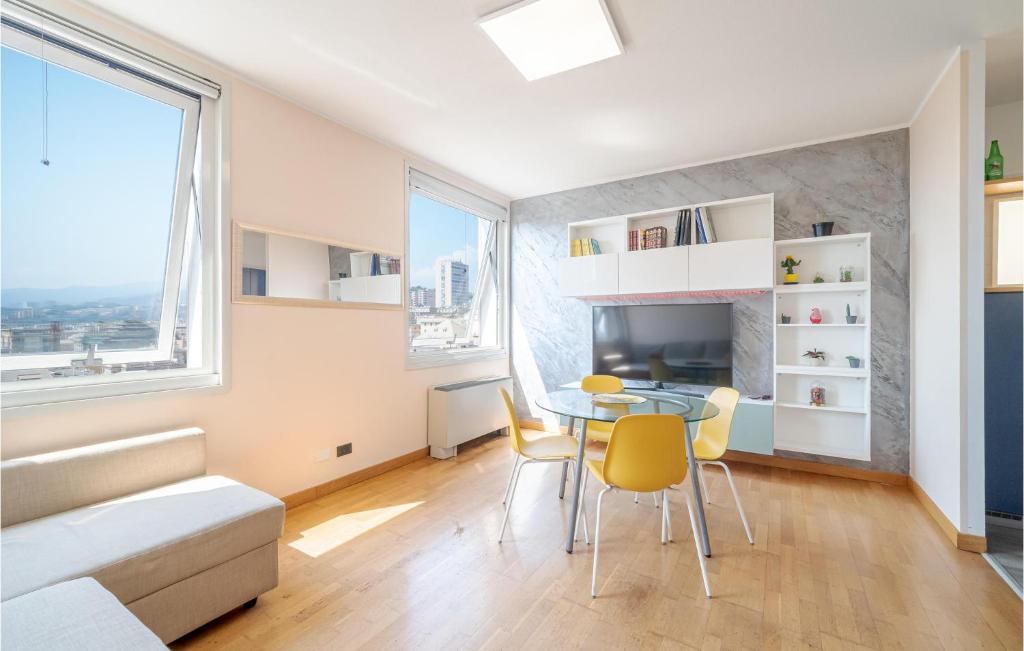 a living room with a table and yellow chairs at Awesome Apartment In Genova With Wifi in Genoa