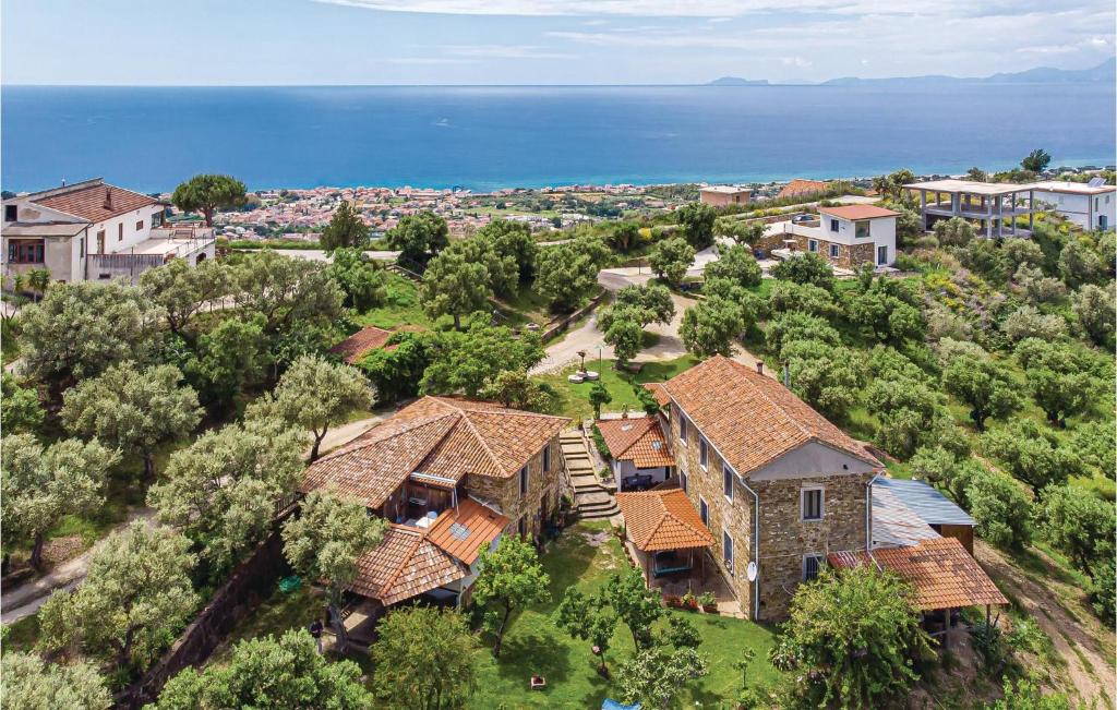 an aerial view of a house with trees and the ocean at Awesome Apartment In Castellabate Sa in Castellabate