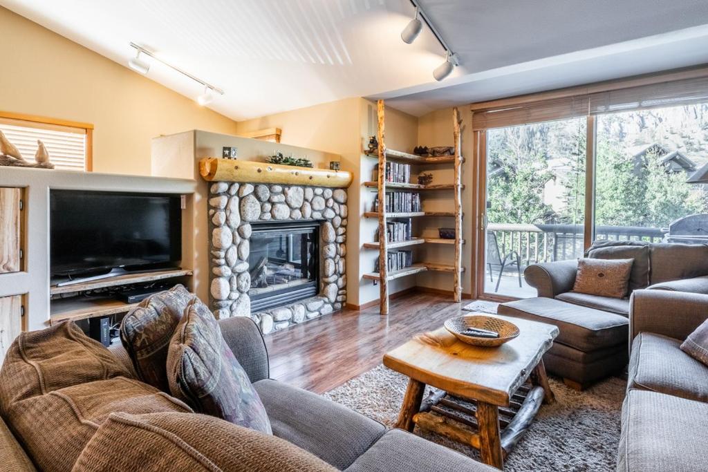a living room with a couch and a fireplace at Snowcreek V 963 in Mammoth Lakes