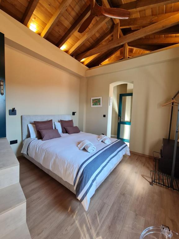 a bedroom with a large bed and wooden ceilings at Selin the stone house in Limassol