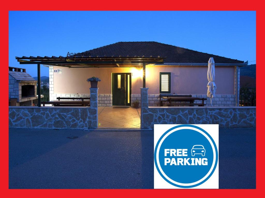 a house with a free parking sign in front of it at Apartments Jobst in Vela Luka