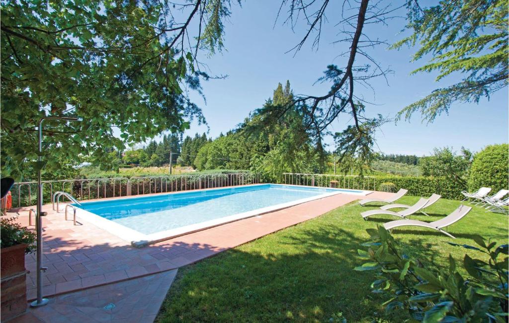- une piscine dans une cour avec 2 chaises longues dans l'établissement Gallonero 1, à Tavarnelle in Val di Pesa