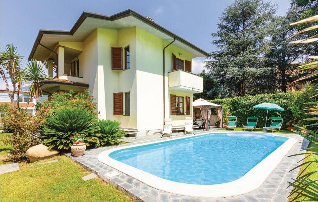 a villa with a swimming pool in front of a house at Villa Anna in Camaiore