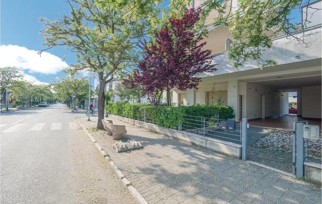 a building on a street with trees and a sidewalk at Orizzonte 1 in Lido di Dante