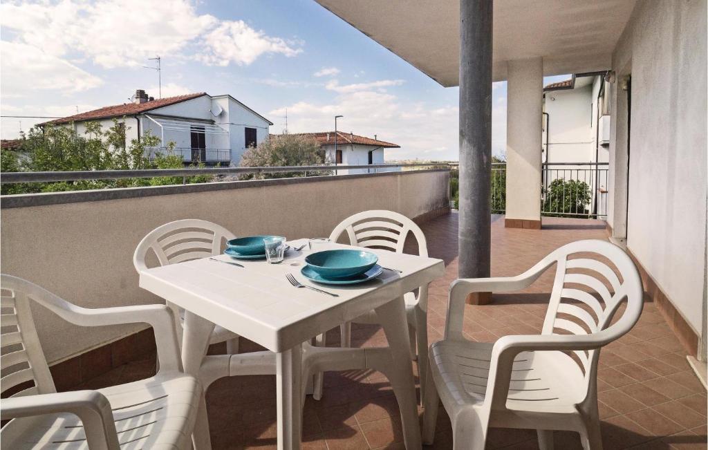 a white table and chairs on a balcony at Orizzonte 2 in Lido di Dante
