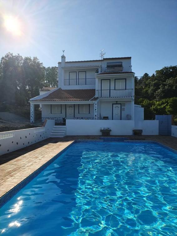 a house with a swimming pool in front of a house at Casa Baptista in Monchique
