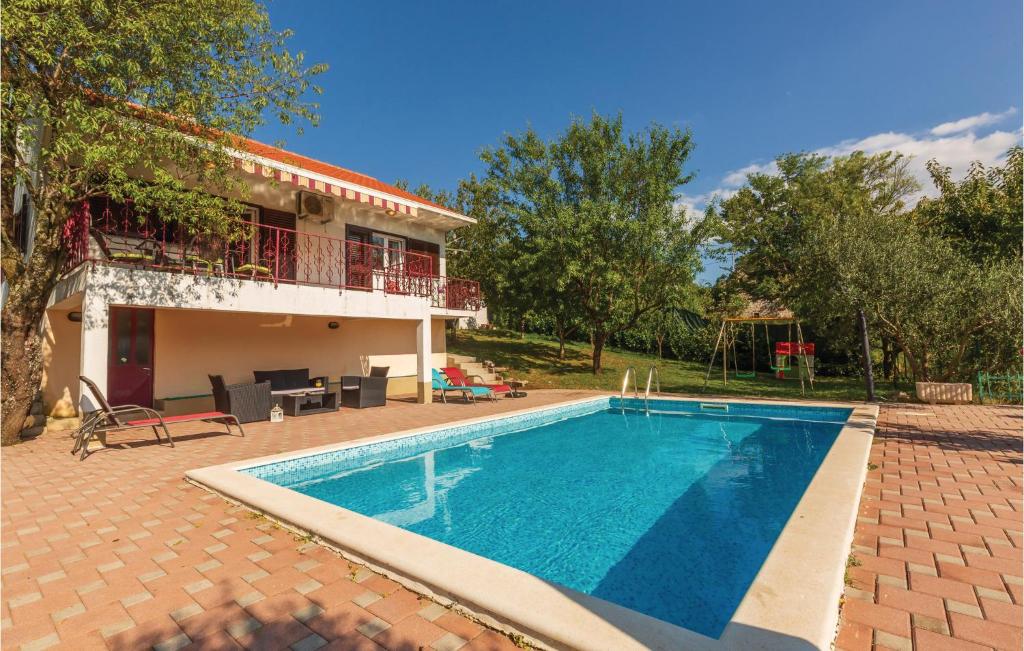 uma villa com piscina em frente a uma casa em Gorgeous Home In Vojnic Sinjski With Wifi em Vojnić Sinjski
