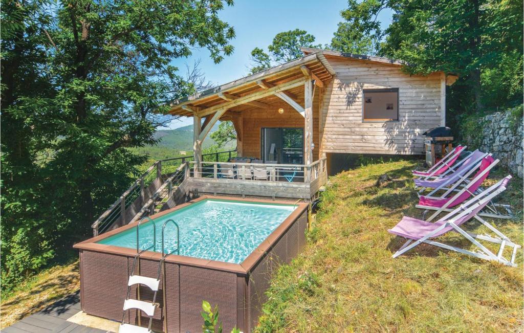 BordezacにあるPet Friendly Home In Bordezac With Outdoor Swimming Poolのスイミングプールと芝生の椅子2脚が備わる家