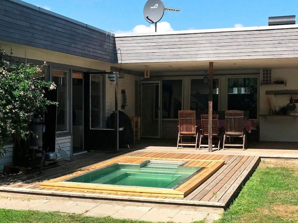 a swimming pool on a deck next to a house at 11 person holiday home in S LVESBORG in Hällevik