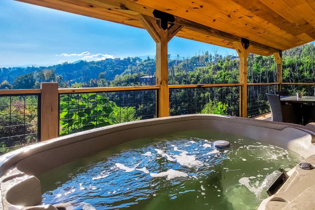 a jacuzzi tub with a view of the mountains at Great Smoky Hideout in Gatlinburg