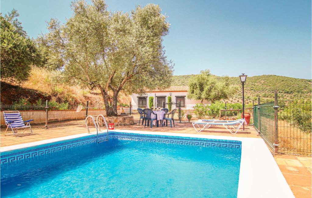a swimming pool in a yard with a house at Gorgeous Home In Villanueva Del Rey With House A Panoramic View in Villanueva del Rey