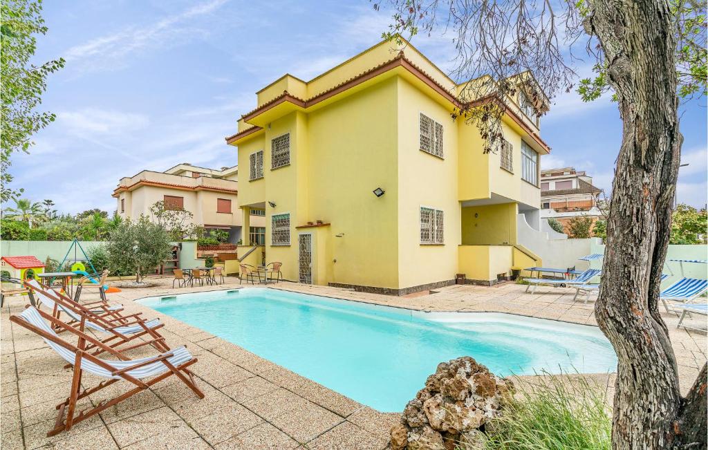 a villa with a swimming pool and a house at 5 Bedroom Amazing Home In Torvaianica in Torvaianica
