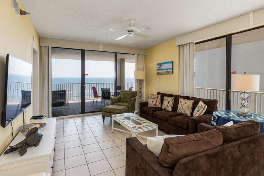 a living room with a couch and a view of the ocean at Romar Place 806 in Orange Beach