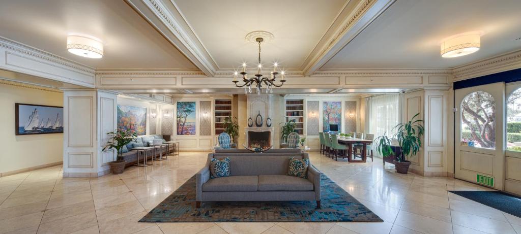 a large lobby with a couch and a table at Ayres Hotel Seal Beach in Seal Beach