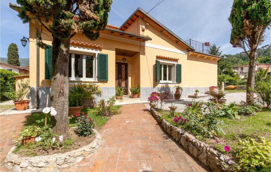 a house with a brick walkway in front of it at 3 Bedroom Lovely Home In Camaiore in Camaiore