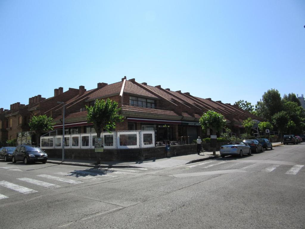 a train station on a street with cars parked outside at Apartamentos Laredo-Playa in Laredo