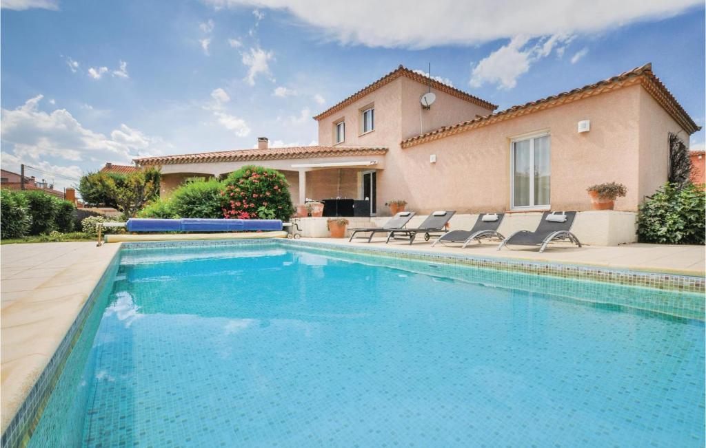 a swimming pool in front of a house at Awesome Home In Villelongue With Kitchen in Villelongue-de-la-Salanque