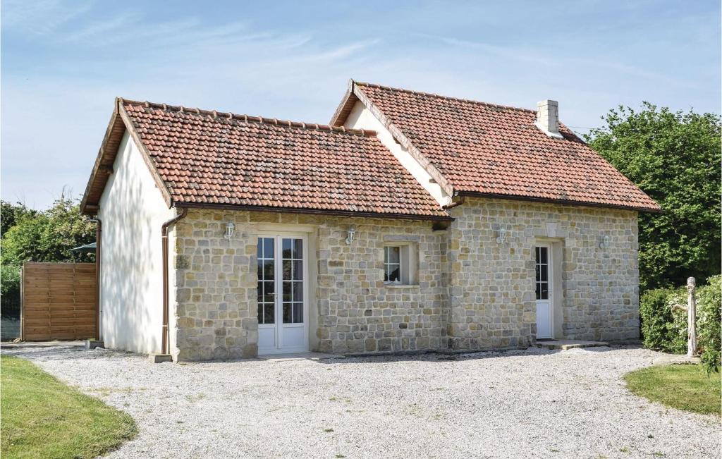 a stone house with a red roof at Nice Home In La Cambe With Kitchen in La Cambe