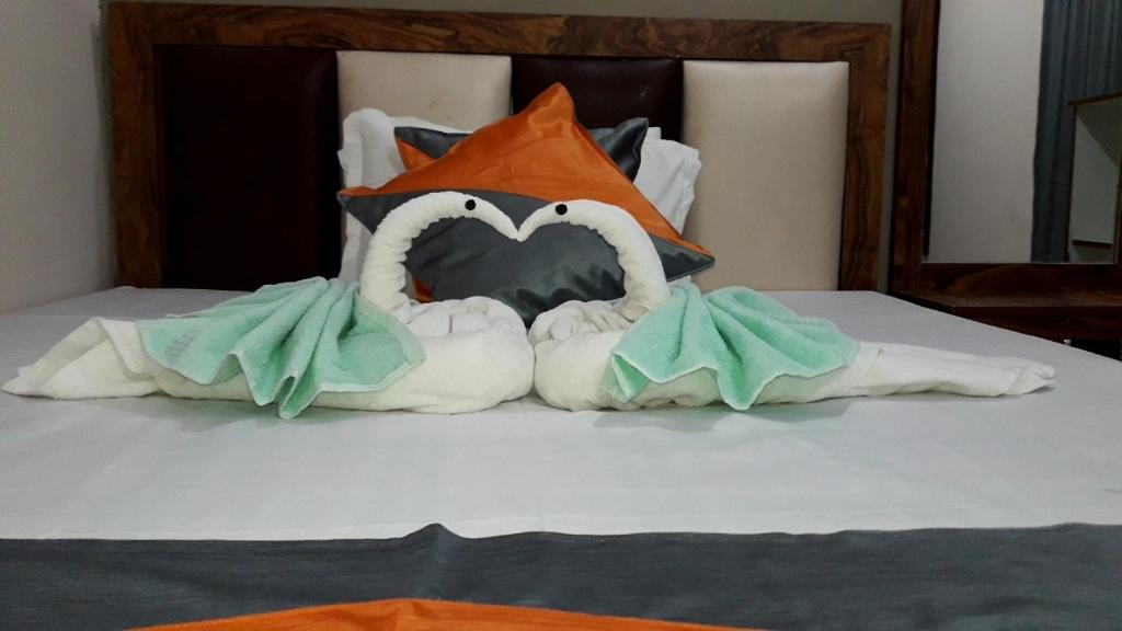 two white swans making a heart shape on a bed at Milan Palace Deoghar in Deoghar
