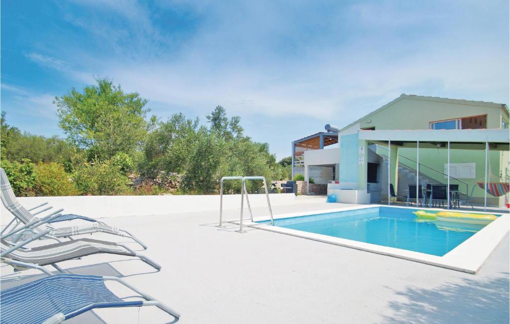 una piscina con una silla y una casa en Pet Friendly Home In Stratincica With Wifi, en Vela Luka
