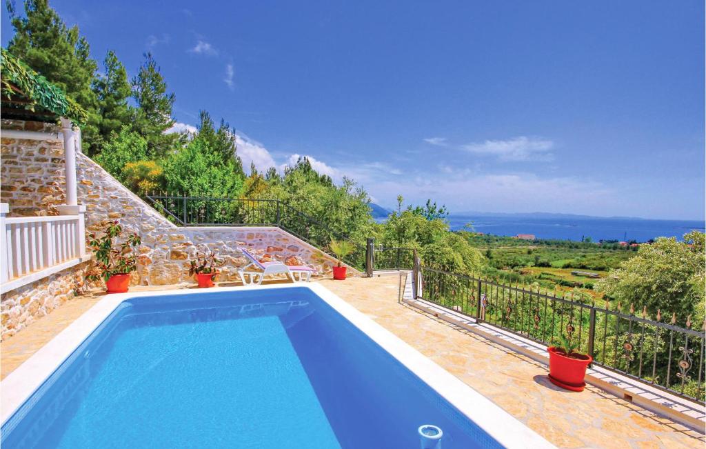 a blue swimming pool on top of a house at Awesome Home In Orebic With Outdoor Swimming Pool in Orebić