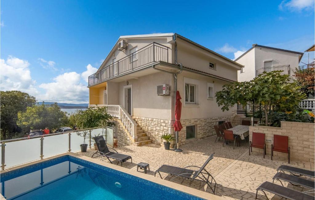 a villa with a swimming pool and a house at Awesome Home In Crikvenica With House Sea View in Crikvenica